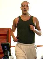 Kevin exercising on treadmill at the gym.
