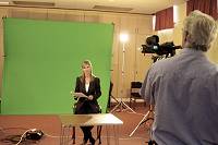 Lisa Jedan acting in front of a green screen.