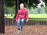 Shot of a boy on a swing.