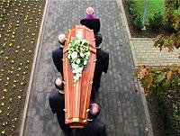 The coffin leaving the church.